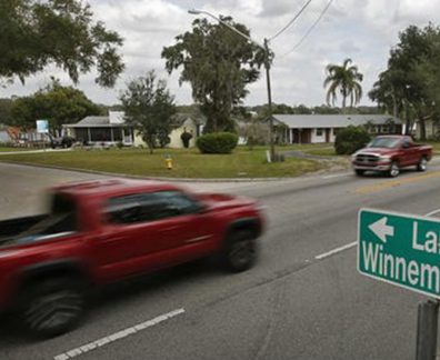 street with sign pointing left to lake winnemissett