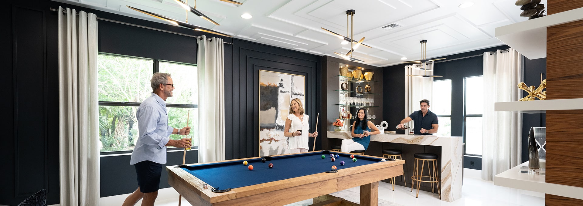 couple playing pool at kolter homes community clubhouse