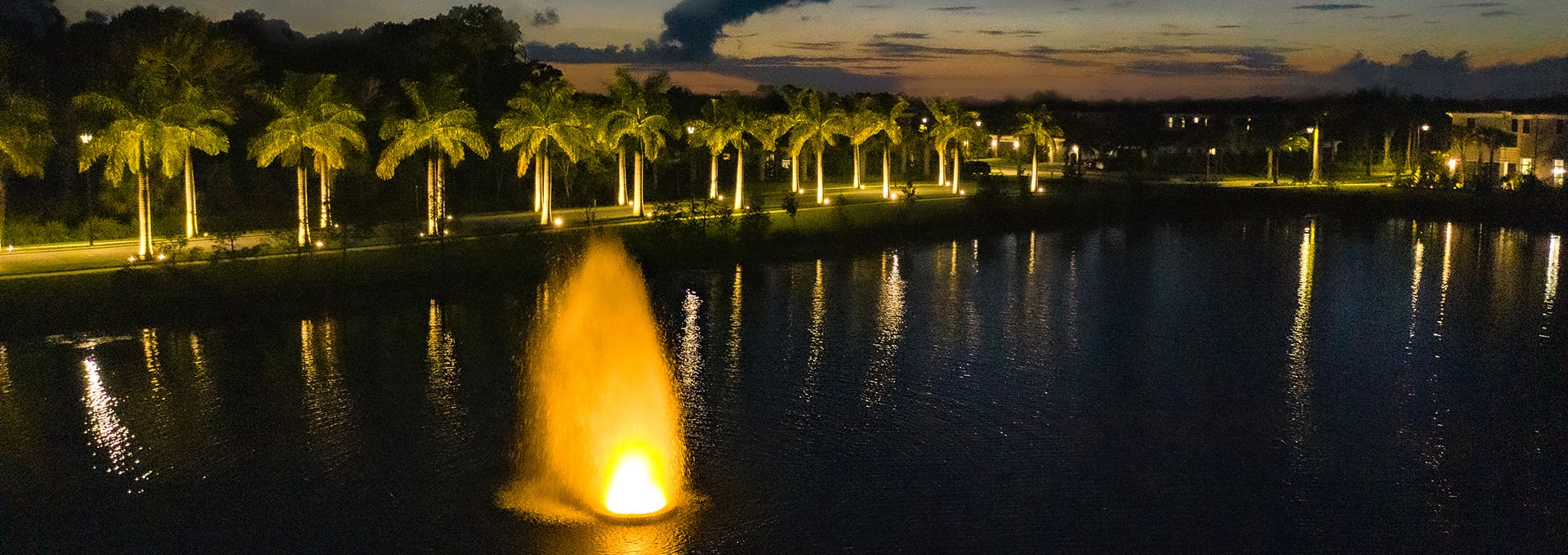 lake at night with fountain lit up at kolter homes community