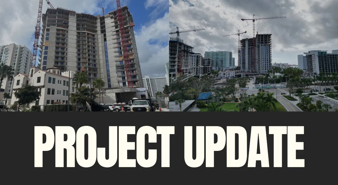 High-rise condominium towers under construction with cranes and scaffolding in an urban waterfront area