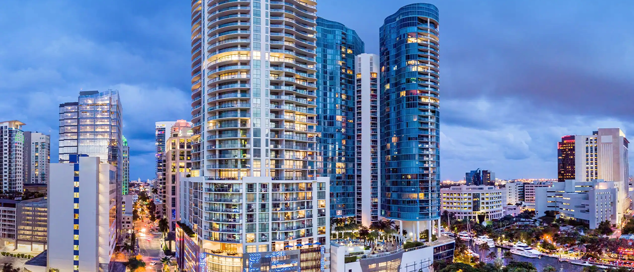 Glass high-rise hotel tower reflecting sunset light in downtown Orlando.
