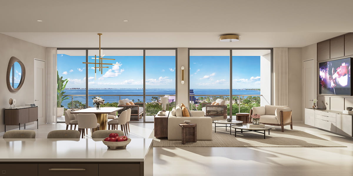 Modern living room with large windows overlooking water and skyline.