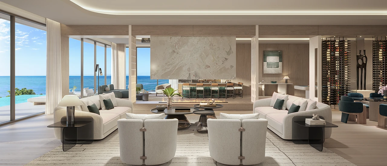 Contemporary oceanfront great room with curved sofas, fireplace, bar, and floor-to-ceiling windows.